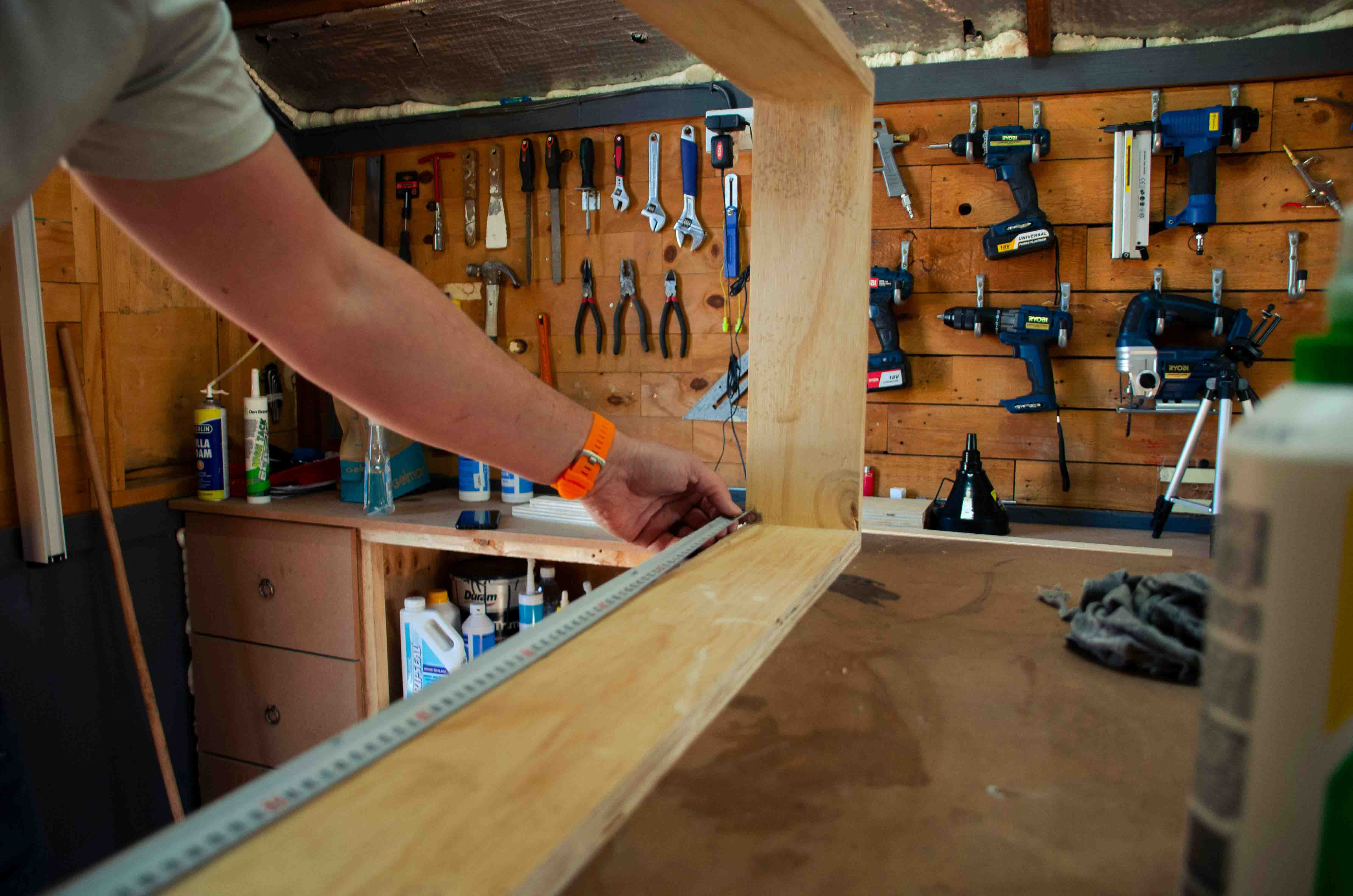 Expert joiner measuring wood with precision